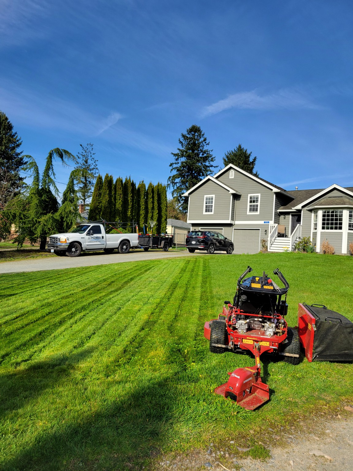 Freshly maintained lawn with JJ Premier Landscaping work truck